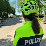 250430_Eine Polizistin beobachtet mehrere Teilnehmende des Pedelectrainings