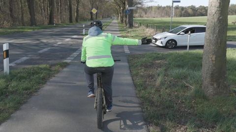 Cyclist gives a hand signal
